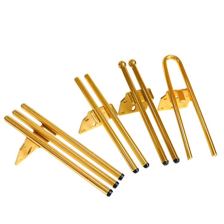 Golden 3-rod metal legs installed on a modern cabinet Application of golden 3-rod solid metal furniture legs on a white contemporary cabinet