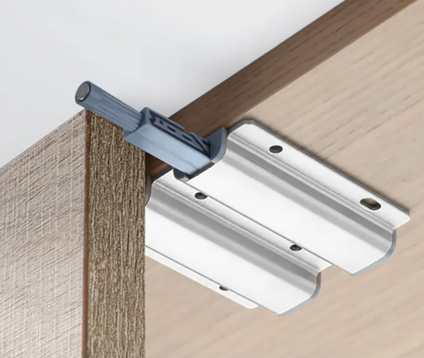 Internal precision spring and magnetic components of the push-to-open cabinet door catch