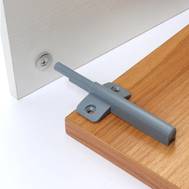 Installation view of the DC006 damper buffer in a modern wooden cabinet system