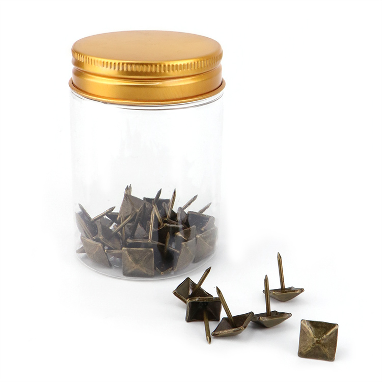 Close-up of antique finish iron decorative nails designed for vintage furniture restoration and upholstery