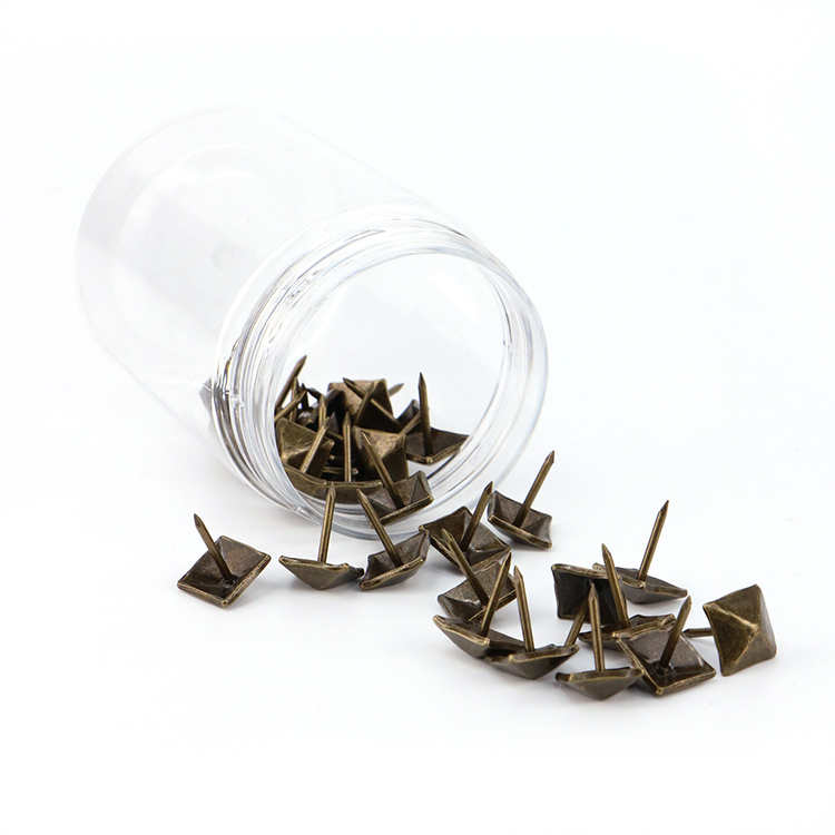 Assorted colors of iron upholstery tacks including regal gold, sleek silver, and antique teal finishes