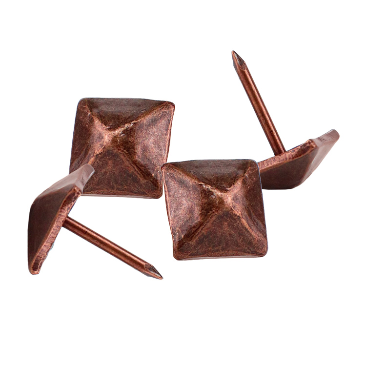 Sleek silver iron decorative nails providing a minimalist boundary for modern upholstered chairs
